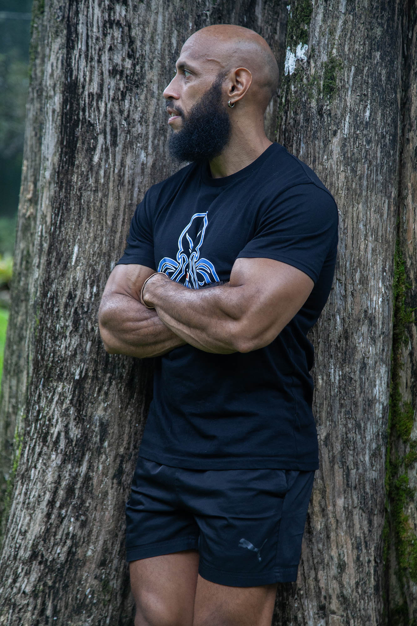 Mengui leaning against tree in Botanical Gardens, Cairns